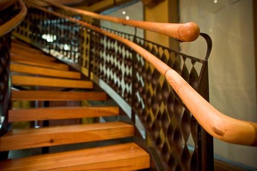 The handrails are custom milled to fit the irregular arc of the spiral 
